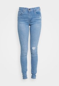 Helle blaue Skinny-Jeans aus Denim. Mit einer hohen Taille, Vordertaschen und einem herzförmigen, beschädigten Detail am rechten Knie.