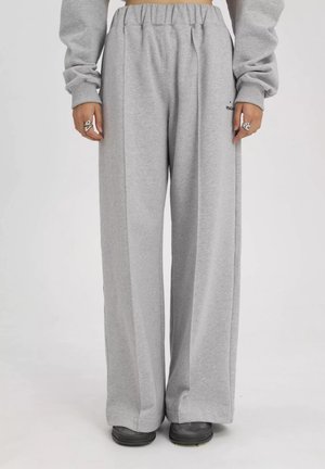 Grijze wijde sweatpants gemaakt van zachte stof met een elastische tailleband. Bevat zijnaad en subtiele logo-details.