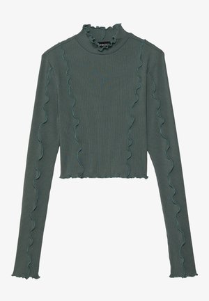 Top côtelé vert olive à manches longues avec bords effet laitue et détails de coutures verticales ondulées, avec un col haut à volants.