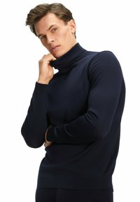 Navyblauer Rollkragenpullover aus weichem Stoff, taillierte Passform mit langen Ärmeln und gerippten Bündchen sowie Saum. Minimalistischer Stil, ohne Muster oder Akzente.