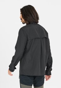 Lange mouw shirt met knopen in donkergrijze stof, met een rugpand ontwerp, lange mouwen en knoopmanchetten. Gegevens met een textuur en minimale details.