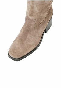 Suede knee-high boot in taupe with a square toe and a black block heel. Features minimal stitching and a smooth texture.