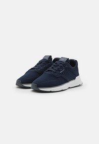 Navy blue athletic shoes with a textured mesh upper, cushioned white midsole, and rubberized outsole. Features traditional lacing and logo accents.