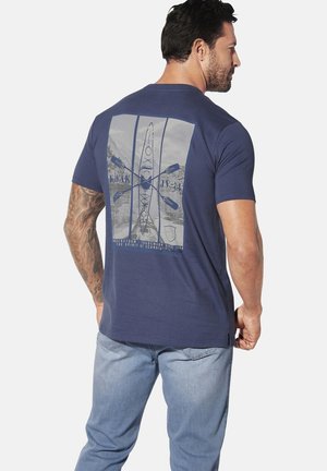 Navy blue cotton t-shirt featuring a graphic print of a kayak and oars on the back, with mountain scenery and text details. Short sleeves.
