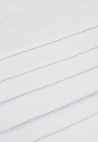 White cotton fabric, folded with a textured finish, showing smooth edges and subtle weave patterns. Clean, minimal design with no visible patterns.