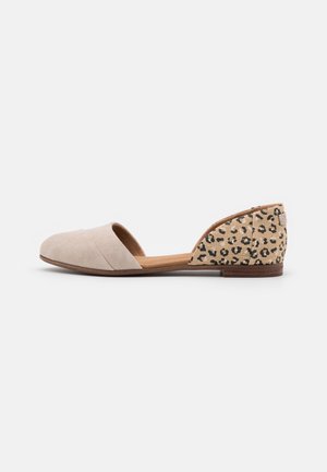 Beige suede flat shoe with a cutout side and a leopard print back heel. The design features a smooth texture and a low-profile shape.