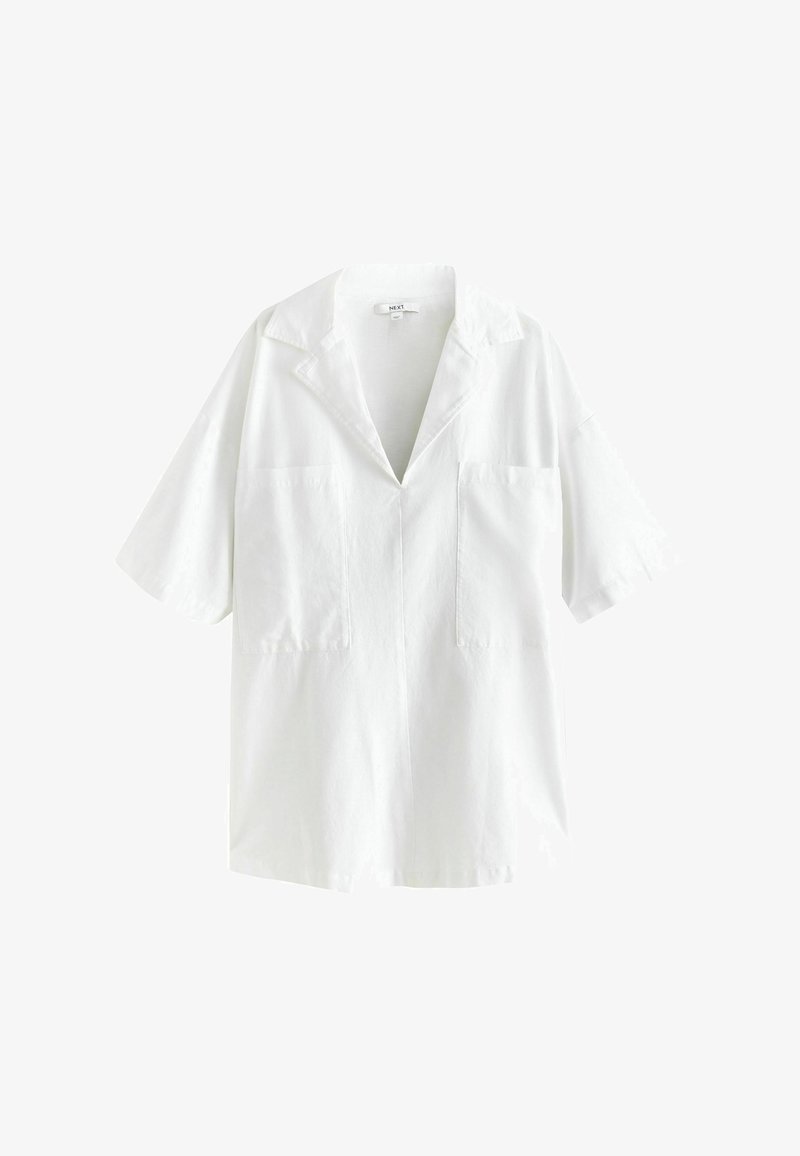 Chemise blanche à manches courtes avec un col cranté, deux poches poitrine à l'avant et une coupe ample.