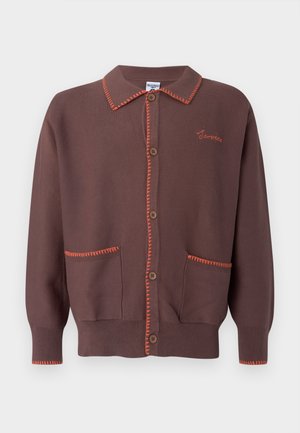 Rjavi kardigan z oranžnimi kontrastnimi šivi, sprednjimi žepi in lesenimi gumbi. Ima ovratni ovratnik in patentirane manšete.