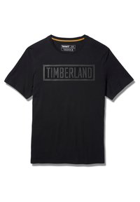 Camiseta de algodón negra de manga corta y cuello redondo, con un logo elevado "TIMBERLAND" en un diseño rectangular a lo largo del pecho.