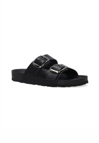 Black slide sandal made of synthetic material featuring two adjustable straps with silver buckles, flat sole, and textured footbed.