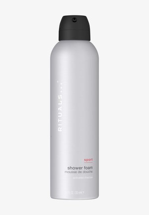 Botella plateada de espuma de ducha Rituals Sport con tapón negro, etiquetada como carbón activado, 200 ml.