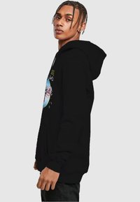Black hoodie featuring a front graphic design with a circular pattern and colorful elements. Soft fabric with a relaxed fit and hood.
