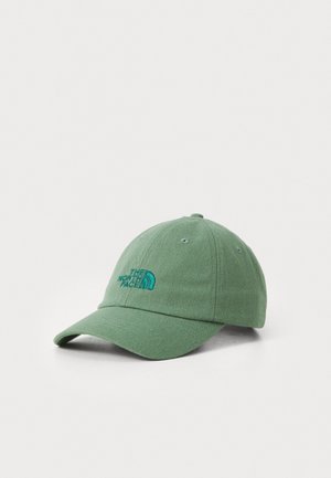 Gorra de béisbol verde claro hecha de tejido texturizado con un logo azul bordado. Visera curva y cinco agujeros de ventilación para transpirabilidad.