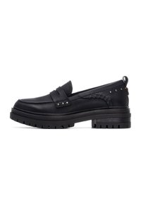 Zapatos negros sin cordones de cuero con un acabado texturizado. Las características incluyen una correa ancha, detalles trenzados y una suela gruesa y estriada.