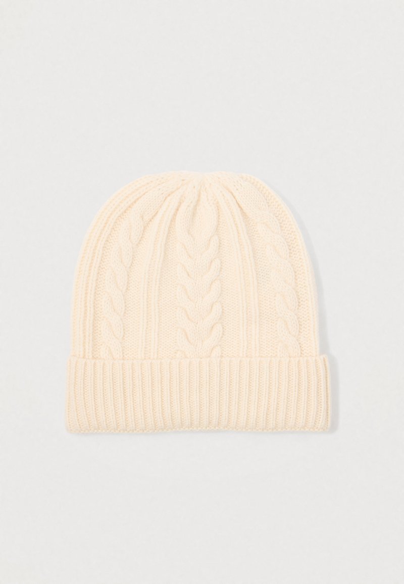 Cream-colored knitted beanie with cable knit pattern and folded ribbed cuff, displayed on a plain light background.