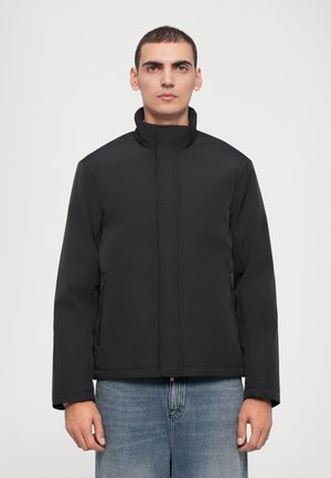 Black, semi-fitted jacket with a stand collar, long sleeves, and zippered side pockets, made of smooth, waterproof material.