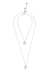 Zilverkleurige hanger ketting met twee lagen; bevat een ronde hanger met gegraveerde tekst en een andere ronde accent daaronder.