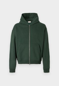 Zelena zip-up kapuca iz mehkega bombažnega blaga, z velikim pokrovom, kenguru žepi ter rebrastimi manšetami in robom. Minimalističen dizajn.