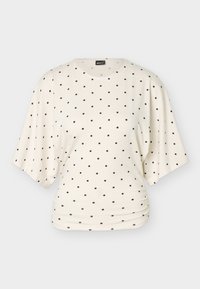 Κρεμ μπλούζα με κοντά μανίκια, άνετη εφαρμογή και μαύρα πουά ομοιόμορφα κατανεμημένα, με ελαφριές πιέτες στη μέση.