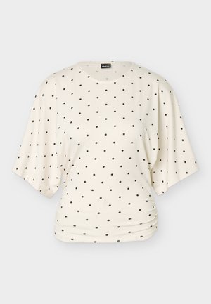 Kremo spalvos trumpomis rankovėmis palaidinė laisvo silueto su juodais taškučiais, tolygiai išdėstytais, su šiek tiek raukinukų ties liemeniu.