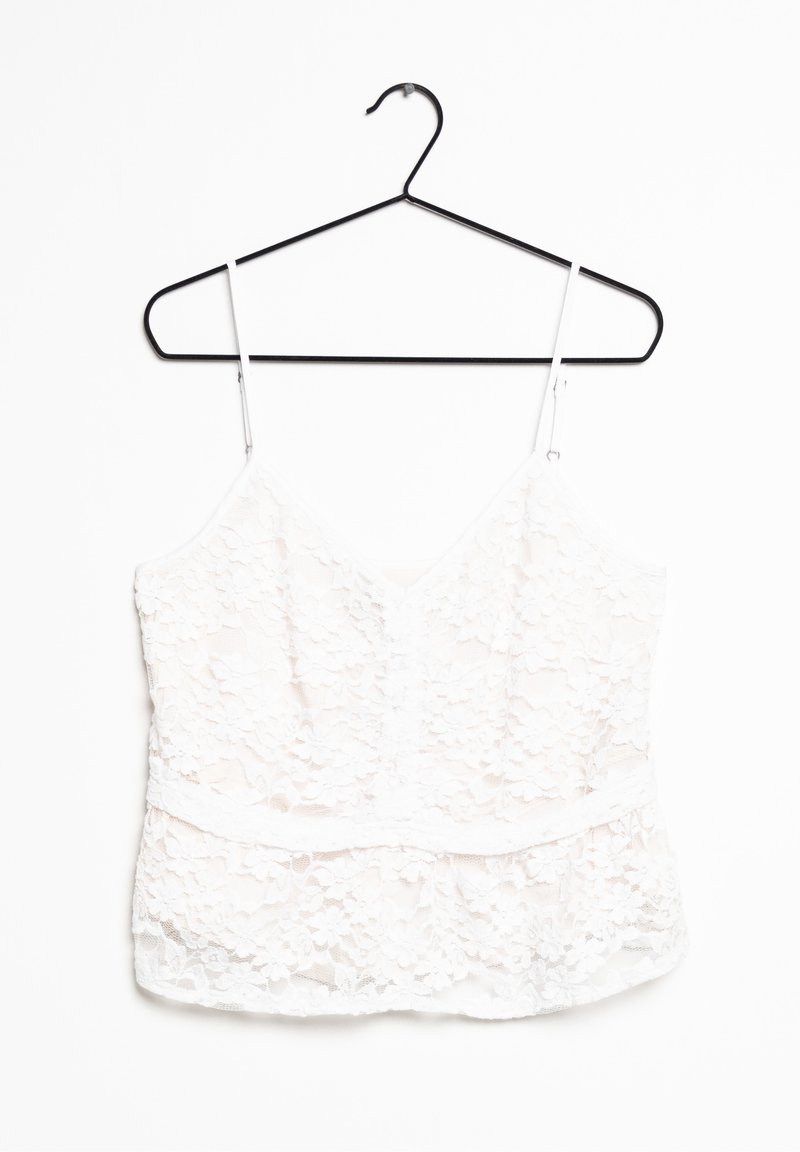 White lace camisole with adjustable straps, v-neckline, floral pattern, and a soft, textured finish hanging on a black hook.
