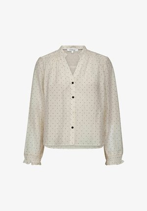 Hellbeige Bluse mit V-Ausschnitt, langen Ärmeln, schwarzer Knopfleiste und kleinen schwarzen Polka-Dots; mit Rüschen an den Manschetten.