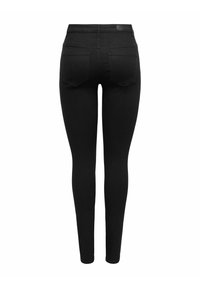 Mustad kõrge vöökohaga kitsad teksad mustas värvuses, millel on sile tekstuur, kaks tagataskut ja puhas disain, kus pole nähtavat riistvara ega kaunistusi.