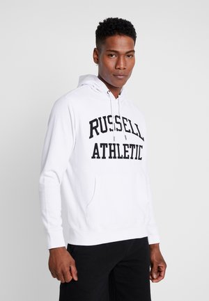 Sudadera blanca de mezcla de algodón, con un bolsillo frontal tipo canguro y un atrevido texto negro "RUSSELL ATHLETIC" impreso en el pecho.