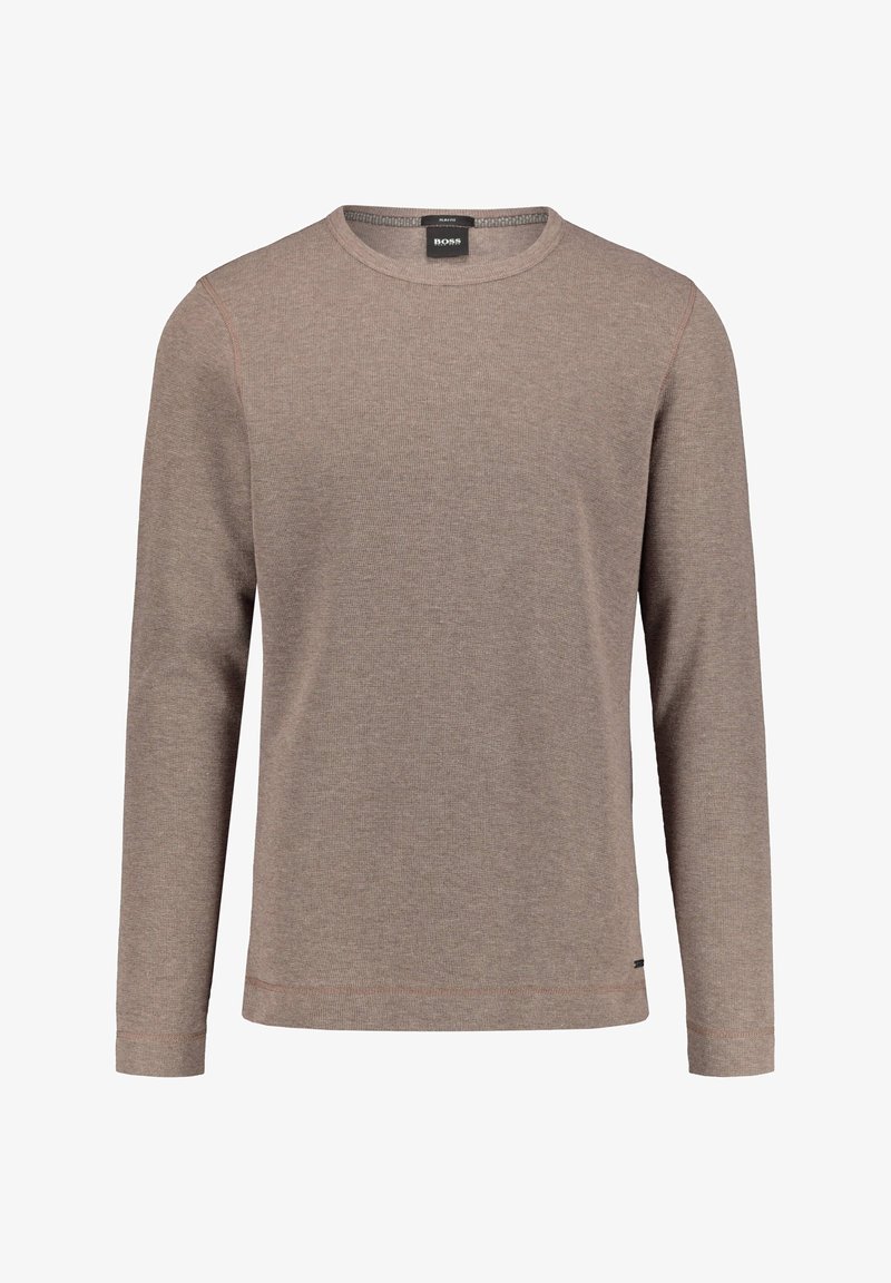 Chemise à manches longues de couleur brun clair, confectionnée en tissu texturé, avec un col rond et des détails de coutures discrètes sur l'ourlet et les manches.