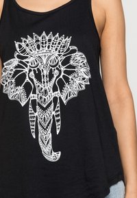 Black tank top featuring a detailed white elephant graphic with intricate patterns. The fabric is soft, with a relaxed fit and rounded hem.