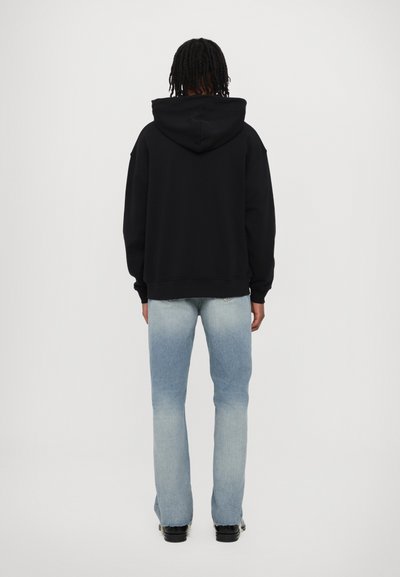 Black hoodie with a drawstring hood, paired with light blue faded jeans. The sweat top features ribbed cuffs and hem, standard fit.