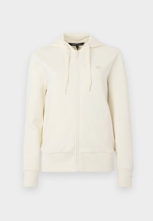 Cream-colored zip-up hoodie with long sleeves, front pockets, adjustable drawstring hood, and subtle "AX" logo on left chest.