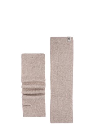Pair of beige knitted arm warmers, one stretched flat and the other scrunched with thumb hole visible.