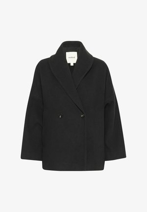 Black double-breasted coat with a wide lapel, made from a soft, textured fabric. Features two front pockets and rounded edges.