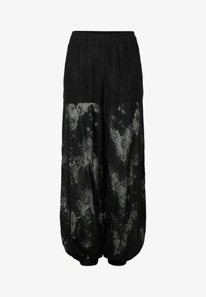 Pantalon en dentelle noire avec un design transparent et des motifs floraux. Taille élastique et poignets froncés aux chevilles pour une forme ballon.