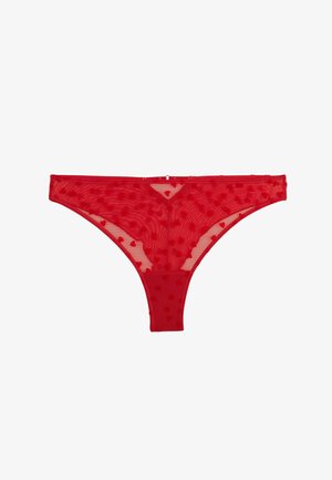 Perizoma rosso trasparente con piccoli motivi a cuore su tutta la superficie, caratterizzato da una sottile cintura in vita e da un taglio a vita bassa.