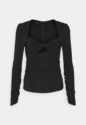 Schwarzes Langarmoberteil mit quadratischem Ausschnitt, einem vorderen Twist-Detail und gerafften Seiten. Verfügt über einen verdeckten Reißverschluss auf der Rückseite.