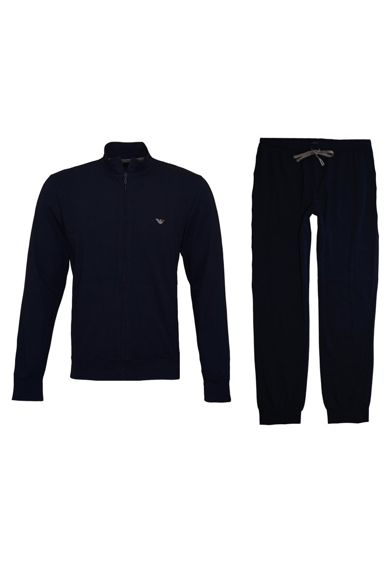 Dunkelblaues Trainingsanzugset mit Reißverschlussjacke und Kordelzughose. Weicher Stoff, gerippte Bündchen und gesticktes Logo auf der Jacke.