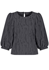 Top nero con texture, maniche a palloncino, scollatura quadrata e chiusura posteriore. Il tessuto presenta un motivo sottile che crea profondità e interesse visivo.