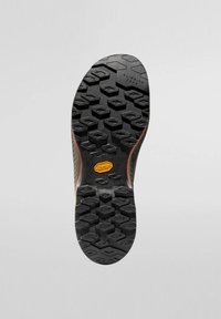 Suola in gomma Vibram con motivo a unghie esagonale, nera con accenti rossi, contrassegnata "ZONA DI ARRAMPICATA" e un logo giallo, superficie testurizzata.
