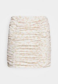 Lightly ruched mini skirt in a soft, pale fabric adorned with small pink floral patterns and green accents, featuring a fitted design.