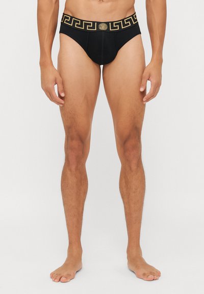 Caleçons pour hommes noirs avec un motif grec doré sur la ceinture et un détail de logo central. Conçus en tissu doux et extensible.