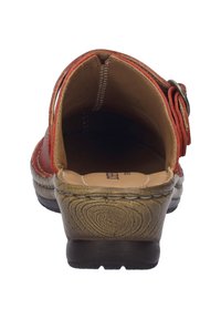Red strapped sandal with a low wooden-effect heel, visible stitching, and a brown leather interior. Buckle detail on the side.