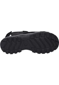 Schwarze Sportschuhsohle mit tiefen Rillen für eine bessere Bodenhaftung, aus Gummi mit einer strukturierten Oberfläche und verstärkten Kanten für Langlebigkeit.