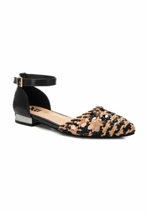 Bailarinas trenzadas con una correa de cuero negra en el tobillo, con punta afilada y una textura trenzada en contraste entre beige y negro. Tacón bajo con acento metálico.