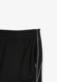 Zwarte sportshorts van een textuurstof, met een witte zijstreep en een ritszak; elastieke tailleband voor aanpassing van de pasvorm.