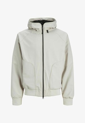 Šviesiai kreminė striukė su užtrauktuku priekyje, su gobtuvu ir elastingomis rankovėmis. Atsišaldoma su šoninėmis kišenėmis ir lygiu, matinio tipo paviršiumi.