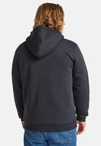 Black hooded sweatshirt with a ribbed hem and cuffs, featuring a smooth texture and a relaxed fit, worn with blue denim jeans.