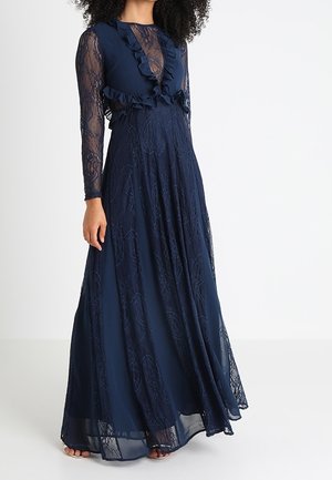 Navy blue long dress with lace long sleeves, ruffle detailing at the neckline, and a flowing skirt. Features intricate lace patterns throughout.