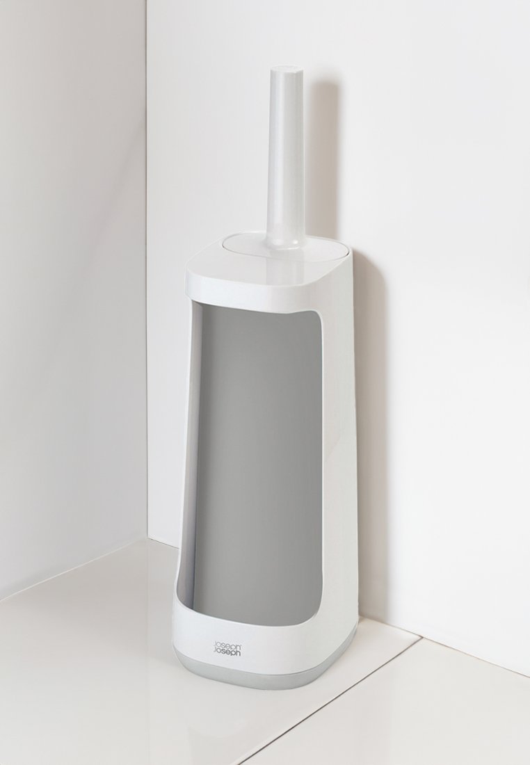 Weißer Toilettenbürstenhalter mit einem schlanken, geschwungenen Design. Verfügt über eine hohe, integrierte Bürste mit einem glatten Griff und einem herausnehmbaren Innenbehälter.